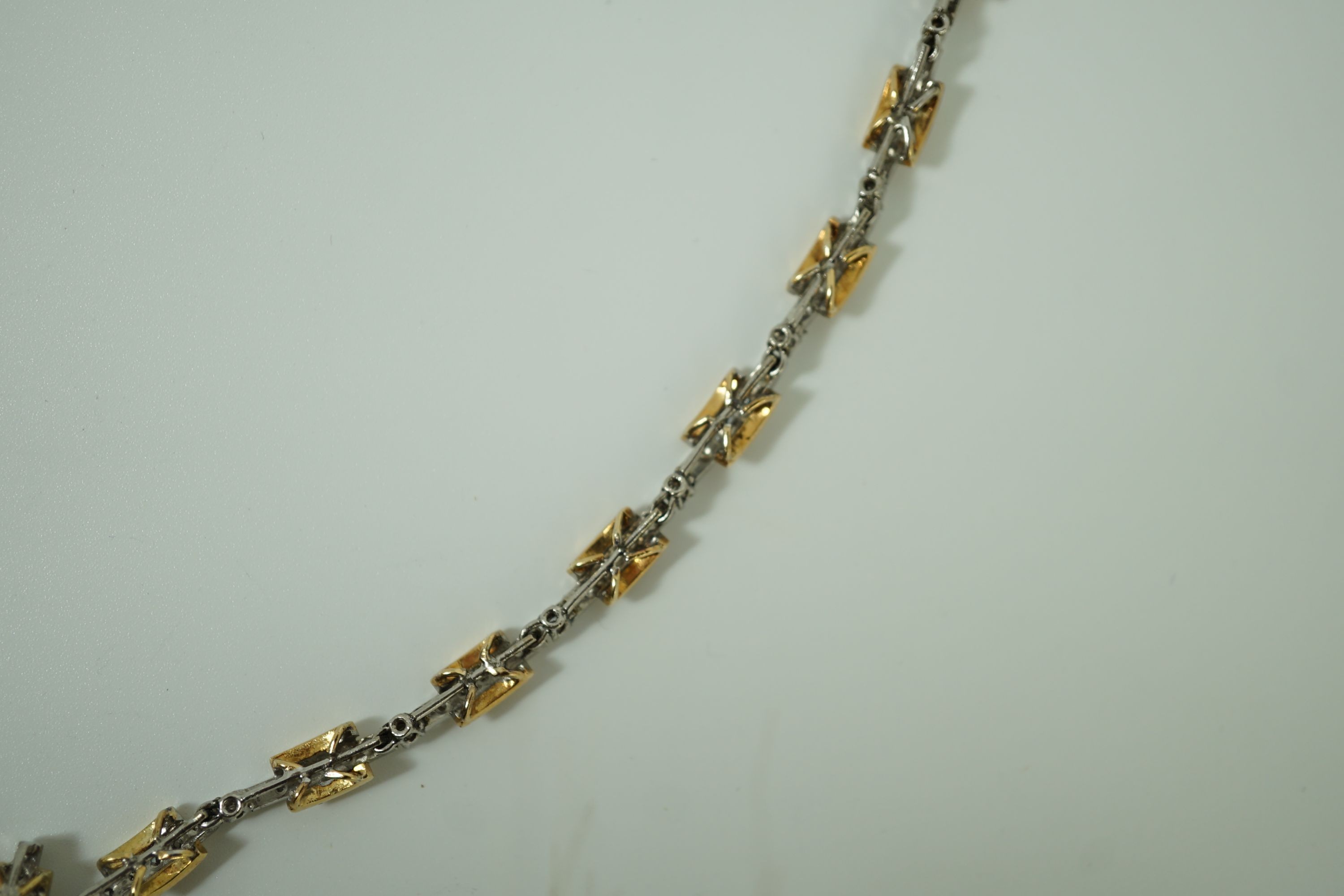 A 20th century two colour gold and diamond set necklace